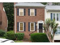 Charming brick townhouse with black shutters, offering a welcoming facade and a well-maintained front yard at 6225 Waterside Ln, Raleigh, NC 27613