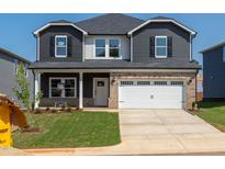 Charming two-story home with a well-manicured lawn and a two car garage at 716 Deschutes Dr, Garner, NC 27529