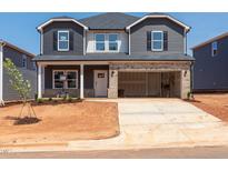 Two-story home with gray siding, brick accents, a two-car garage, and freshly planted landscaping at 716 Deschutes Dr, Garner, NC 27529