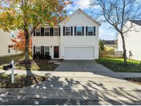 Charming two-story home featuring a two-car garage and a well-maintained lawn in a friendly neighborhood at 821 Stackhurst Way, Wake Forest, NC 27587