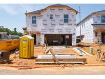 New home under construction featuring Tyvek home wrap and building materials at 848 Ottawa Dr, Garner, NC 27529
