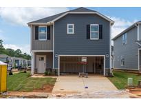 Two-story home with a two-car garage, gray siding, black shutters, and a well-maintained front lawn at 848 Ottawa Dr, Garner, NC 27529