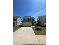 Charming two-story home featuring a two-car garage and a well-manicured front yard at 99 Still Hand Dr, Clayton, NC 27527
