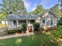 Charming single-story home with a welcoming front porch and well-maintained yard with mature shade trees at 1012 Bermuda Run, Knightdale, NC 27545