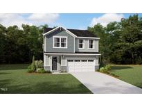 Charming two-story home showcasing stylish siding, a welcoming front door, and an attached two-car garage at 107 Vulcan St, Garner, NC 27529