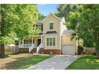 Charming two-story home with manicured lawn, attached garage and welcoming front porch at 121 River Hills Dr, Clayton, NC 27527
