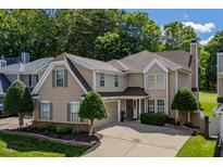 Charming two-story home with well-manicured landscaping and a spacious driveway on a sunny day at 121 Walter Hagen Dr, Mebane, NC 27302