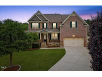 Beautiful two-story brick home with a well-manicured lawn and inviting curb appeal at 1704 Fawn Chase Ct, Wake Forest, NC 27587