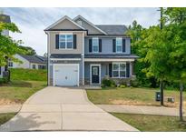 Charming two-story home with garage, landscaped front yard, and a welcoming facade at 173 Forsyth Pkwy Pkwy, Clayton, NC 27520