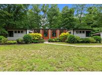 Charming single-story home with lush landscaping and a well-manicured lawn at 3095 Champs Way, Mebane, NC 27302