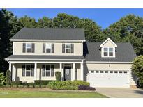 Charming two-story home featuring a landscaped front yard, inviting entrance, and attached garage at 395 Wyndham Place Dr, Fuquay Varina, NC 27526