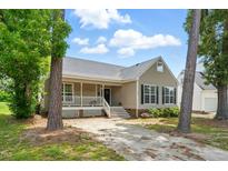 Charming home featuring a covered front porch and well-maintained landscaping at 4905 Knightsbridge Way, Raleigh, NC 27604