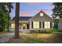 Charming single-Gathering home with inviting front porch and manicured lawn at 4905 Knightsbridge Way, Raleigh, NC 27604