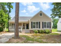 Charming single Gathering home with a cozy front porch and well-maintained landscaping at 4905 Knightsbridge Way, Raleigh, NC 27604