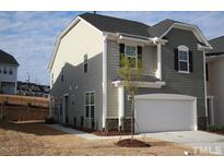 Two-story home featuring a two-car garage, neutral siding, and a well-manicured lawn at 526 Catalina Grande Dr, Cary, NC 27519