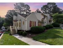 Charming townhome featuring red shutters and lush landscaping in a well-maintained community at 6516 Hearthstone Dr # 6516, Raleigh, NC 27615