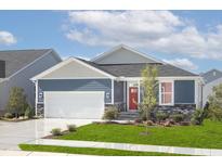 Charming single-story home featuring a red front door, stone accents, and a well-manicured lawn at 904 Emmer St, Rolesville, NC 27571