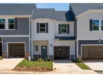 Charming two-story townhome with gray and white siding and attached garage at 1035 Winding Spring Dr, Mebane, NC 27302