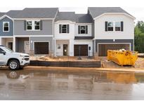 New construction townhomes feature covered parking and modern design at 1035 Winding Spring Dr, Mebane, NC 27302