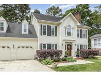 Charming two-story home with a well-manicured lawn and attached two-car garage at 104 Odessa Cir, Cary, NC 27513