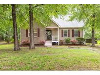 Charming home with brick and siding, red shutters, landscaped yard, and cozy front porch at 1510 Bungalow Ave, Durham, NC 27703