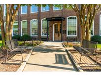 Beautiful brick building with large windows, benches, sidewalk and a lovely flower bed at 1535 Caraleigh Mills Ct # 111, Raleigh, NC 27603