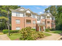 Inviting condo with brick and siding exterior, balconies and landscaped grounds at 1700 Tiffany Bay Ct # 303, Raleigh, NC 27609