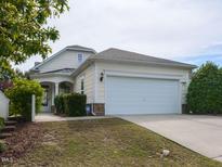 Charming home featuring a two-car garage, landscaped yard, and inviting entrance at 207 Callum Pl, Cary, NC 27519
