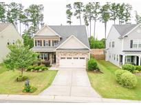Charming two-story home featuring a well-manicured front yard, a two-car garage, and lovely landscaping at 2511 Kestrel Heights Ct Ct, Durham, NC 27703