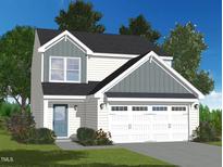 Charming two-story home with white siding and a two-car garage, beautifully landscaped at 2700 Barrington Dr, Raleigh, NC 27610