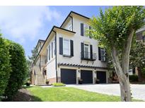 Charming three-story home with black shutters, three-car garage, and well-manicured lawn at 2800 Charleston Oaks Dr, Raleigh, NC 27614