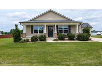 Charming one-story home with a well-manicured lawn and inviting front porch at 286 Beaver Tavern Dr, Benson, NC 27504