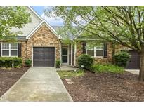 Attractive house with stone facade, well-kept landscaping, and a two-car garage at 309 Plank Bridge Way, Morrisville, NC 27560