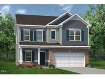 Charming two-story home with brick accents, a welcoming front porch, and a two car garage at 32 Freedom Heights Ln # 151, Smithfield, NC 27577