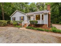 Charming home featuring brick accents, bay window, and lush landscaping at 4004 Bamburgh Ln, Apex, NC 27539