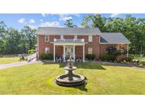 Stately brick home boasts a charming front yard and fountain focal point at 4024 Rural Retreat Rd, Burlington, NC 27215