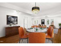 Bright dining area featuring a modern chandelier, stylish furniture, and an open-concept design at 507 Price Ave, Durham, NC 27701