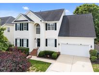 Charming two-story home with a well-maintained lawn, black shutters and a two-car garage at 5942 Big Nance Dr, Raleigh, NC 27616