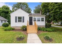 Charming home featuring a welcoming front porch, neat landscaping, and a freshly painted exterior at 601 Acorn St, Burlington, NC 27215