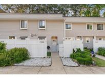 Charming townhouse with white picket fence and well-maintained landscaping at 7365 Sandy Creek Dr, Raleigh, NC 27615