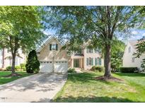 Charming brick home with a two-car garage, green shutters, and a well-maintained front yard at 9112 Mission Hills Ct, Raleigh, NC 27617