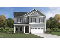 Charming two-story home featuring stone accents, a two-car garage, and a well-manicured lawn at 1205 Cosmic Dr, Durham, NC 27703