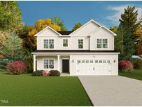 Charming two-story home with white siding, a well-manicured lawn, and a two-car garage at 122 Jones Creek Ln, Lillington, NC 27546