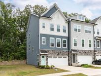 Beautiful two-story townhome with a two-car garage and a well-manicured lawn at 2008 Van Hook Ln, Apex, NC 27502