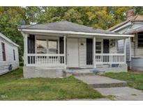 Charming single-story home featuring a cozy front porch and a well-maintained yard in a quiet neighborhood at 230 Park Ave, Rocky Mount, NC 27801