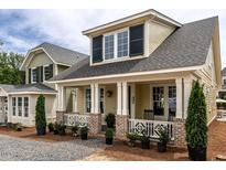 Inviting home with a charming front porch, stylish columns, and well-manicured landscaping enhancing its curb appeal at 2637 Sidford Aly, Raleigh, NC 27608