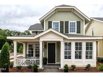 Charming home featuring a welcoming front porch, a black front door and manicured landscaping, creating a cozy curb appeal at 2641 Sidford Aly, Raleigh, NC 27608