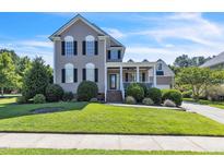 Charming two-story home with a welcoming front porch and well-manicured lawn at 30155 Pharr, Chapel Hill, NC 27517