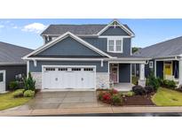 Charming two-story home with a two-car garage, inviting porch, and well-maintained landscaping at 33 Davidson St, Clayton, NC 27527