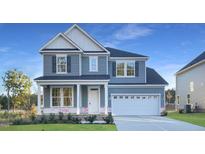 Charming two-story home with a two-car garage, covered porch, and beautifully landscaped front yard at 3500 Bailey Lake Dr, Fuquay Varina, NC 27526
